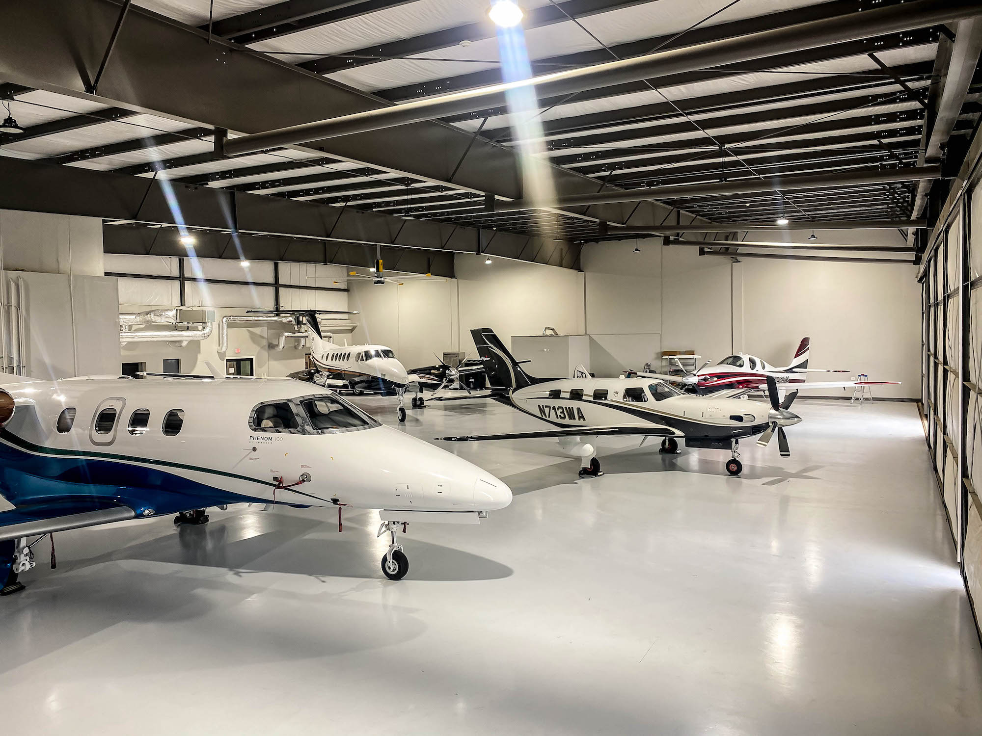 Multiple airplanes parked within the hangar